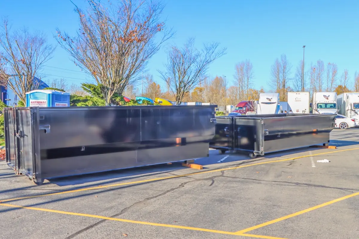 Professional dumpster rental service with roll-off container on residential driveway in North Syracuse
